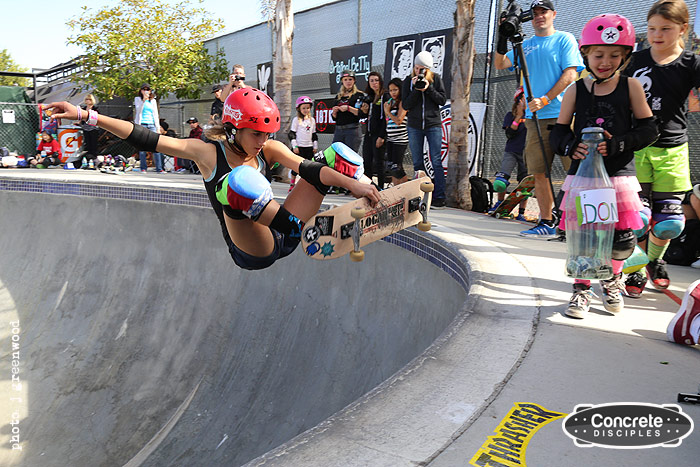 Arianna Carmona - frontside air, with the Pink Helmet Posse on 'donation patrol'.